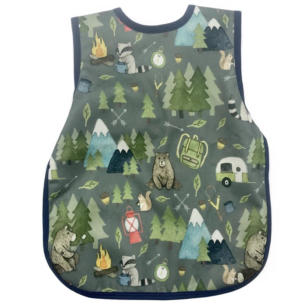 Bapron- bib apron is a hybrid between the two. It is full coverage and ties in the back. This one has blue trim and has bears, raccoons, campfires, trees and trailers on it.
