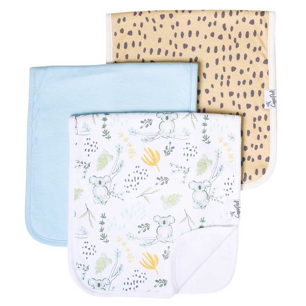 3 burp cloths with different patterns, one with koalas, one is tan with brown spots and one is solid baby blue.