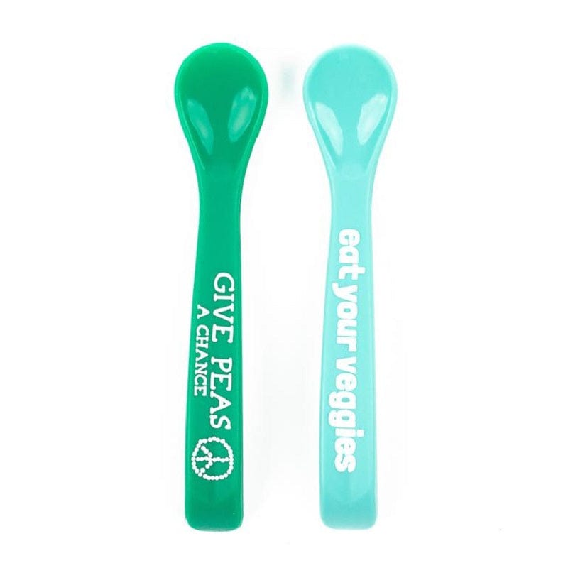 Bella Tunno's green silicone spoon says, "Give peas a chance" with a peace sign, and the light blue one says, "eat your veggies".