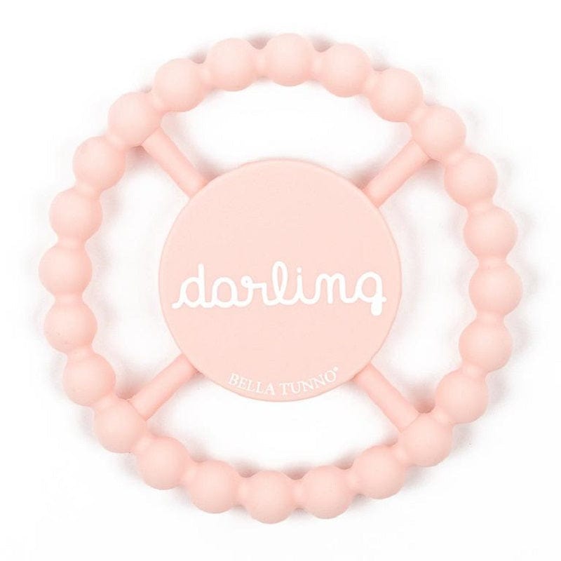 Circular light pink teether that says "darling" in white cursive lettering.