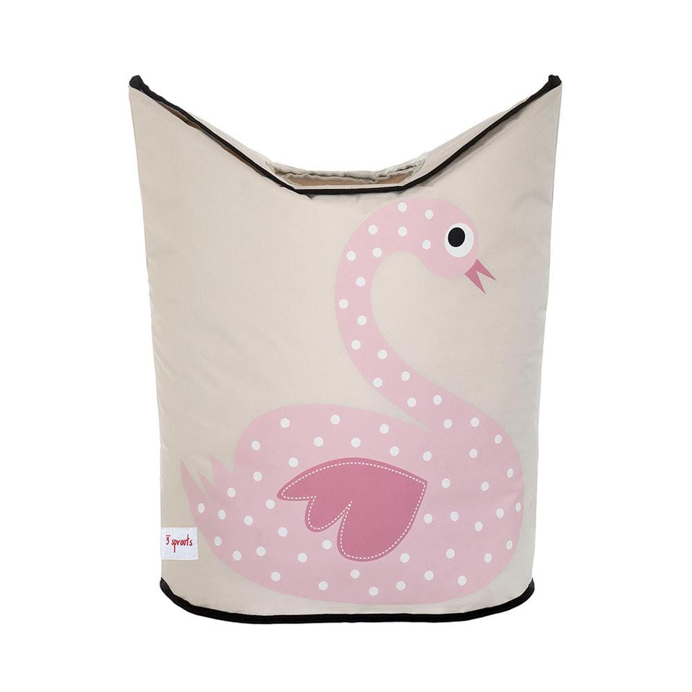 3 Sprouts laundry hamper with 2 large handles and mesh bottom. Black piping edged the tan  material with a pink swan with white polka dots on the front.