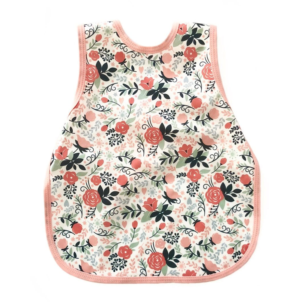 Bapron- bib apron is a hybrid between the two. It is full coverage and ties in the back. This one has a pink trim and is covered in flowers. 