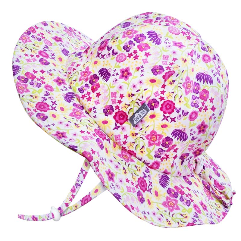 Wide brimmed sun hat for kids. Purple and pink flowers on white background. Includes adjustable chin strap and toggle adjustment for head circumference.